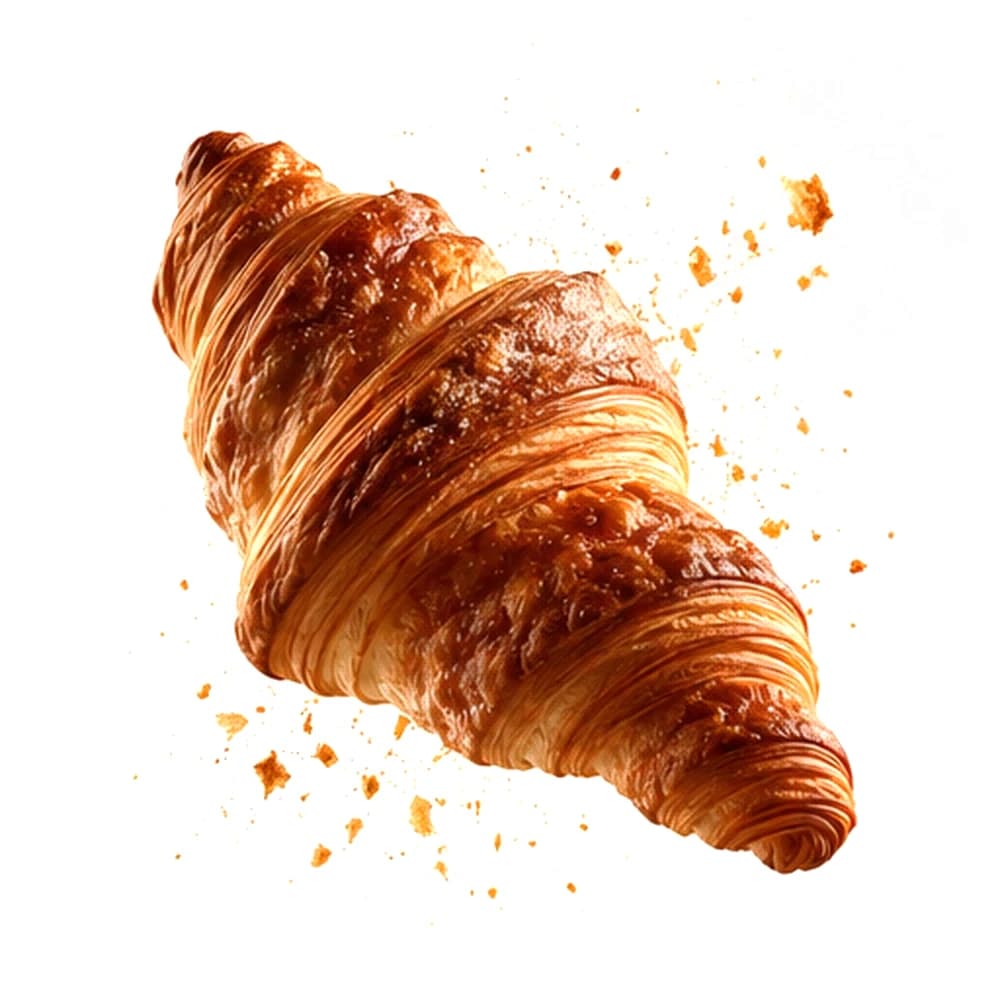 Goldbraun gebackenes Croissant mit fein aufgeblätterten Teigschichten, schwebend über verstreuten Blätterteigkrümeln